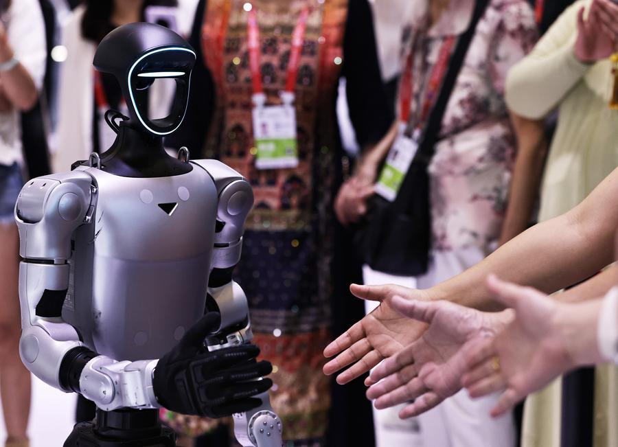 Unitree G1 humanoid robot greeting visitors at an exhibition event